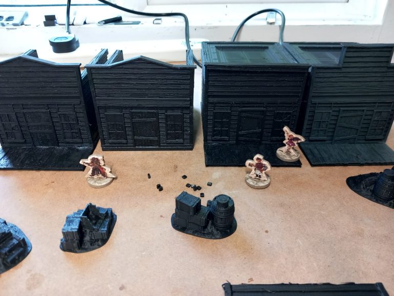 The  western buildings are generic enough to work with historical but the roof sections give them away as prefabricated park pieces. I've tried to recreate the schemes of the two buildings you can put together with the  card starter set