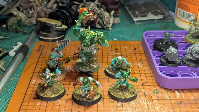 Three additional goblins (I forgot to grab one where I had him sitting on a can, but there are 5 linemen, along with Nobbla Blackwort and a trained troll complete now.)