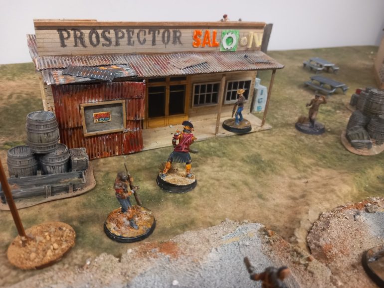 The nukaworld pieces for dry Rock Gulch work well for the new Vegas setting if you want barrels with fallout items scattered amongst them.  Here they are with my scratchbuilt goodsprings table