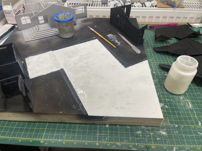 PVA the road and driveway, sieve over the tilegrout