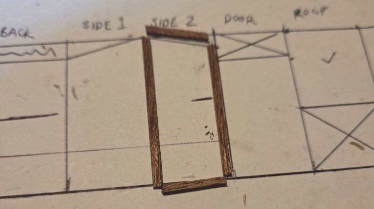 I drew out actual size plans for the small building and used these to cut the wood to size