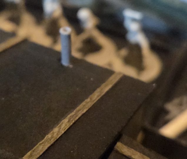 Chimney top glued in corresponding location on roof. This is a piece of plastic sprue with one end drilled out. I still need to make a rain cap.