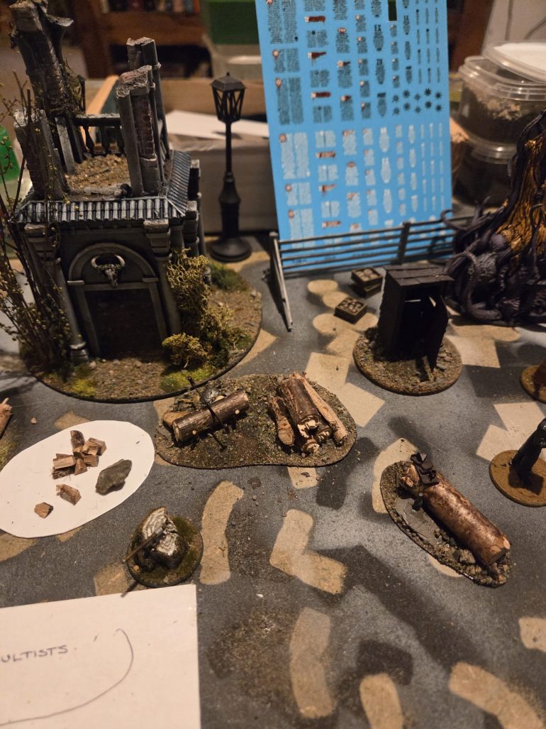 Inspired by the axe in the tree trunk, I have utilised some sticks to make a log seat, a pile of large logs with a sawing station. And I have still to finish the small logs ready for the wood burner, just need to cut up lots of small logs, also need some to be stacked by the house.