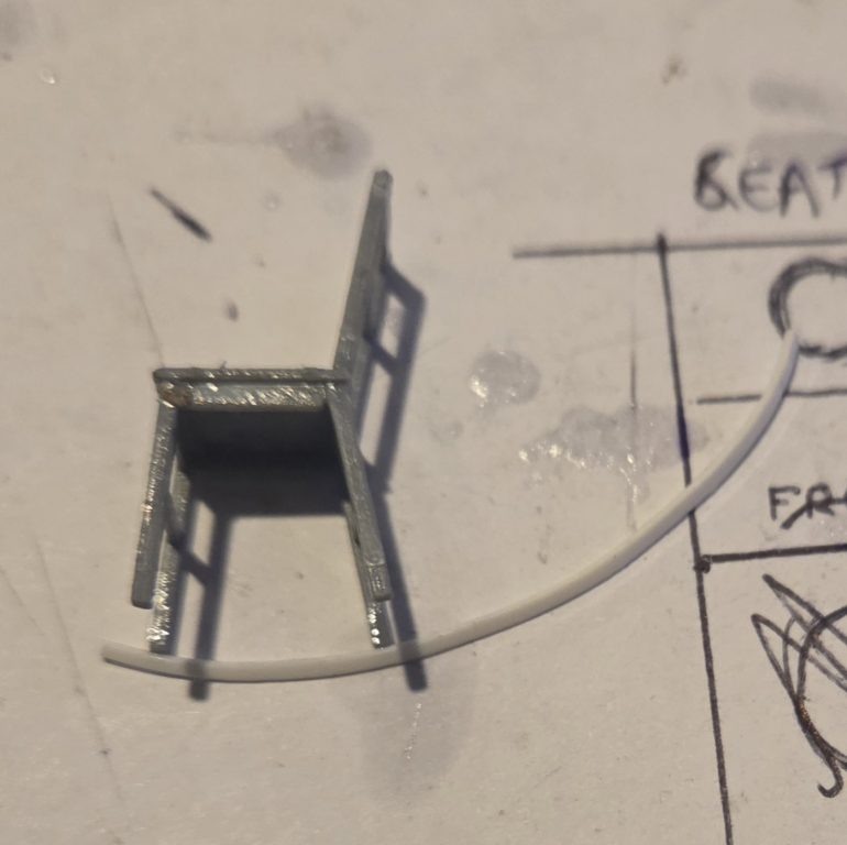 Every old house in the woods needs a rocking chair on the veranda, again i looked on line and all the options I found were horrible and expensive.The rocking chair is made from two stool kits, the legs and base are the stool, I just changed the angle of the legs as they were originally straight down, the rocker is .ade from a strip of plastic card curled ny hand.er is a thin strip of plastic card curled by hand. The back is another set of stool legs.