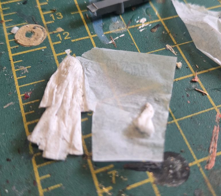 A cloth and a long coat made from tissue paper and PVA glue.