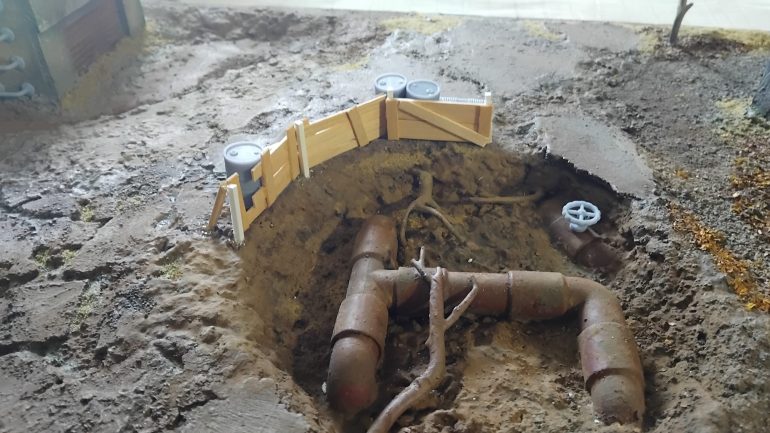 Fencing off the crater to make some much needed cover in the centre of the board. Coffee sticks and styrene rods