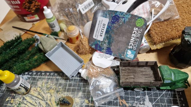 Some terrain pieces I've been working on. Ubiquitous temu cheap trucks. Home made hedges, haystack and fields courtesy of a 50p B&M doormat.