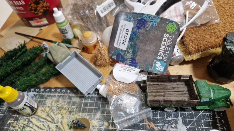 Some terrain pieces I've been working on. Ubiquitous temu cheap trucks. Home made hedges, haystack and fields courtesy of a 50p B&M doormat.