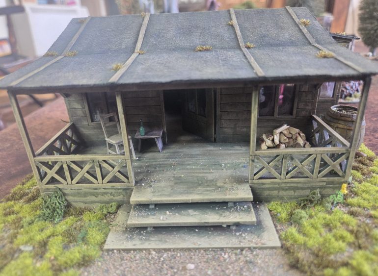 I wanted to add some fine scatter/debris on the steps and porch. To do this I used a peice of paper to mask off the front of house (particularly the windows) spayed the porch and steps with Matt Varnish, finely scattered a mix of leaves and grit leaving the main through way to the front door fairly clear. Once I was happy this was sealed in with another coat of matt varnish.