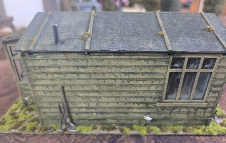 You can see the odd tufts of moss on the roof, and a few tools against the wall.