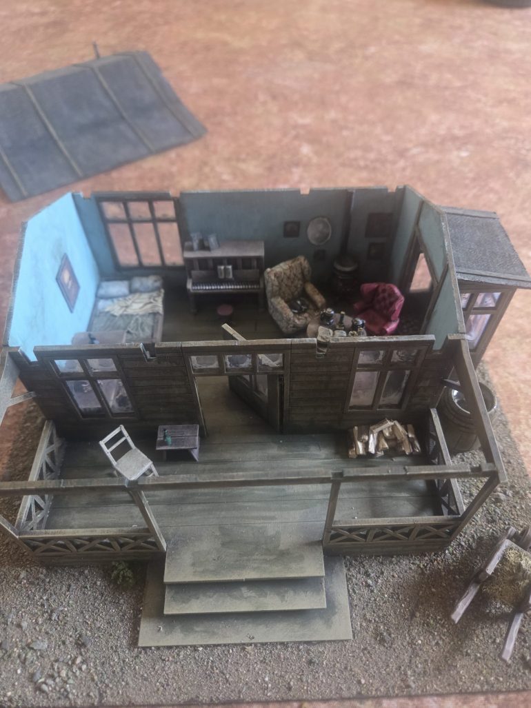 Furniture and accessories added to the interior. You can also see the dusty grey wash I added to the window, after applying i wiped away what i could leaving a dirty edge to all the windows