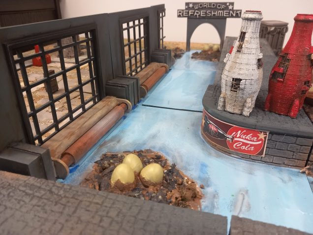 Painting up my river a nice poppy blue because nuka cola quantum is radioactive so never looses its shine. Also added some posters and painted up my detritus and eggs 