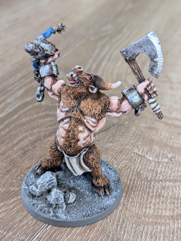 I decided I wanted to try some variation in skin tone for my other minotaurs. This was painted using Vallejo skin tones, working from Athena Skin, to Rosy Flesh and then Pale Flesh, with white highlights. As the sculpts had exchangeable hands, this one has the upper torso of the poor knight in his right hand 