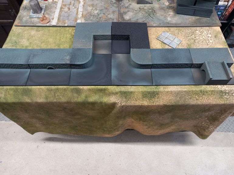 I found some harbour sections on mymini factory which I'll be using for other projects but work for the river of cola