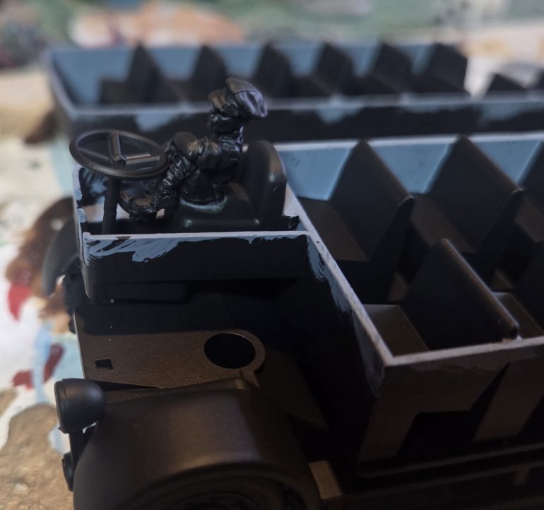 I found this WW1 driver in my bits box, with a bit of trimming and sanding he fitted in nicely.