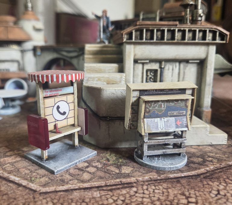 I had this Prisoner scenery unmade in a box from a couple of years ago. This is long out of production, I found this on ebay. On the telephone booth I enhanced the striped shade sticker provided by giving it an Agrax Earthshade wash folowed by a highlight of pure white on the white stripes and a bright red (Army Painter Fiery Vetmillion). I built the map board incorrectly so I had to save it with some plastic card surround. 