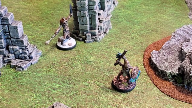 A neanderthal shaman uses a curse to send an Aztec hero scurrying in the other direction.