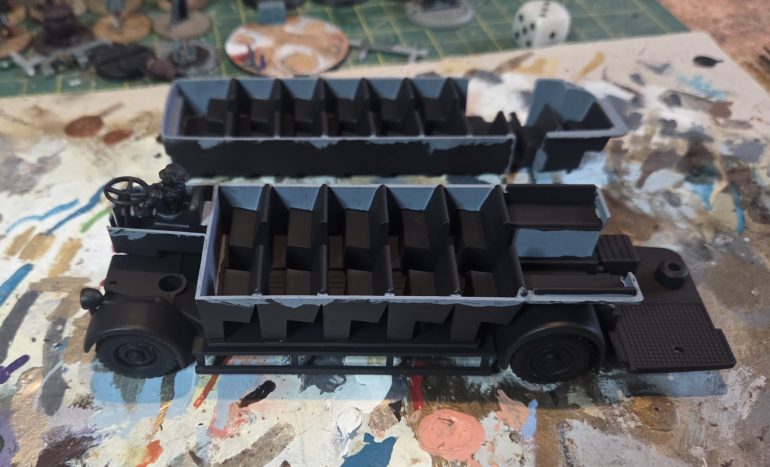 I subassembled the three elements that made up the chassis and lower deck. This and the upper deck were undercoated black. When dried the walls of the interior pieces were painted in the AK grey.