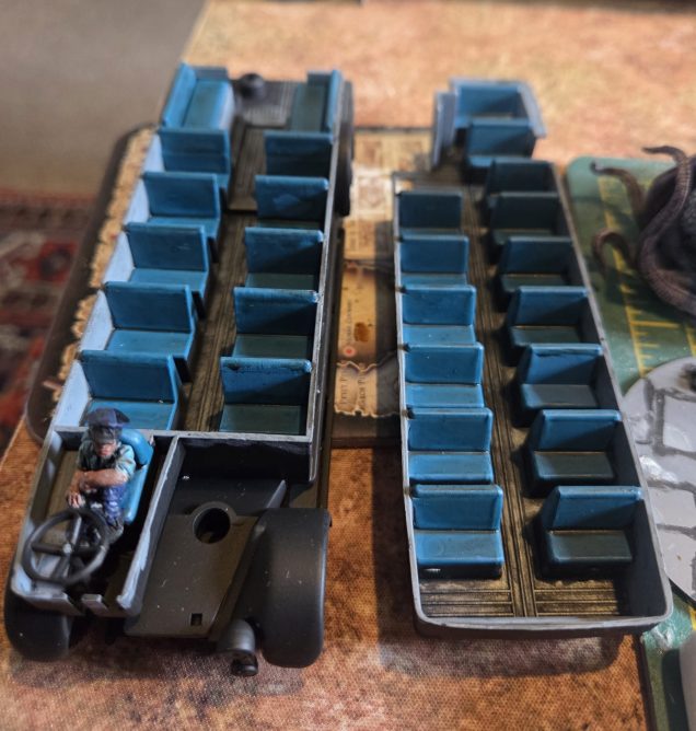 The flooring was painted in AP trash metal, the seats in Vallejo Model Colour Turquoise and the driver painted in base colours. This was then given a dark wash.