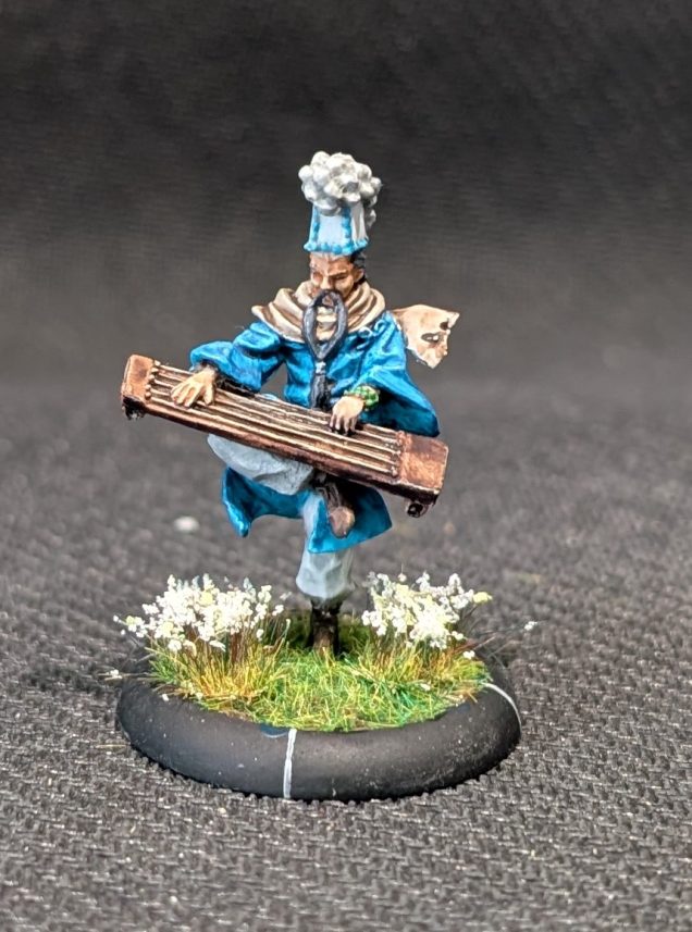 Tsutsumi, an elderly monk playing an instrument while balanced on one leg