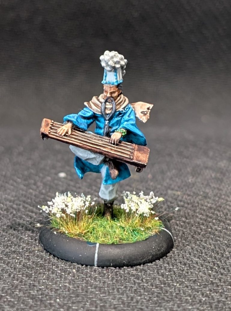 Tsutsumi, an elderly monk playing an instrument while balanced on one leg