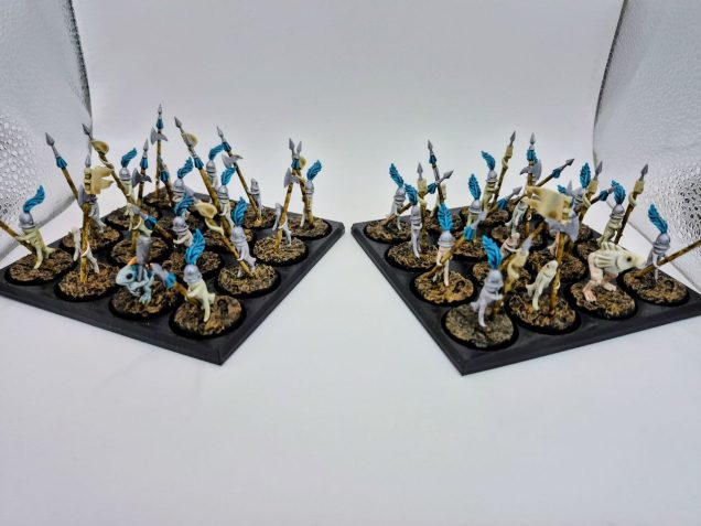 Pikemen - Standing upright on slippery, webbed feet, these helmeted fish-pikemen present a pitiful sight in their oversized sallets and tattered feathers. Upon encountering an enemy line, they enthusiastically wave dirty white banners atop their pikes, drooping their fishy heads in apparent defeat. The moment their opponents relax or step forward to accept the surrender, the formation drops into a lethal wall of iron points, and the pikemen surge forward with a chorus of wet, bubbling shrieks.