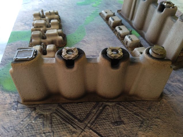 They smoke stacks bigger pieces are packaging from a laptop box. I think these pieces slide on either end of the laptop, the smaller pieces folded in to keep it all stable, but I snipped those off and made those modular smaller buildings.