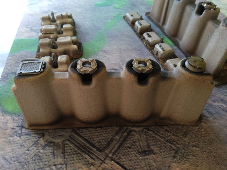 They smoke stacks bigger pieces are packaging from a laptop box. I think these pieces slide on either end of the laptop, the smaller pieces folded in to keep it all stable, but I snipped those off and made those modular smaller buildings.