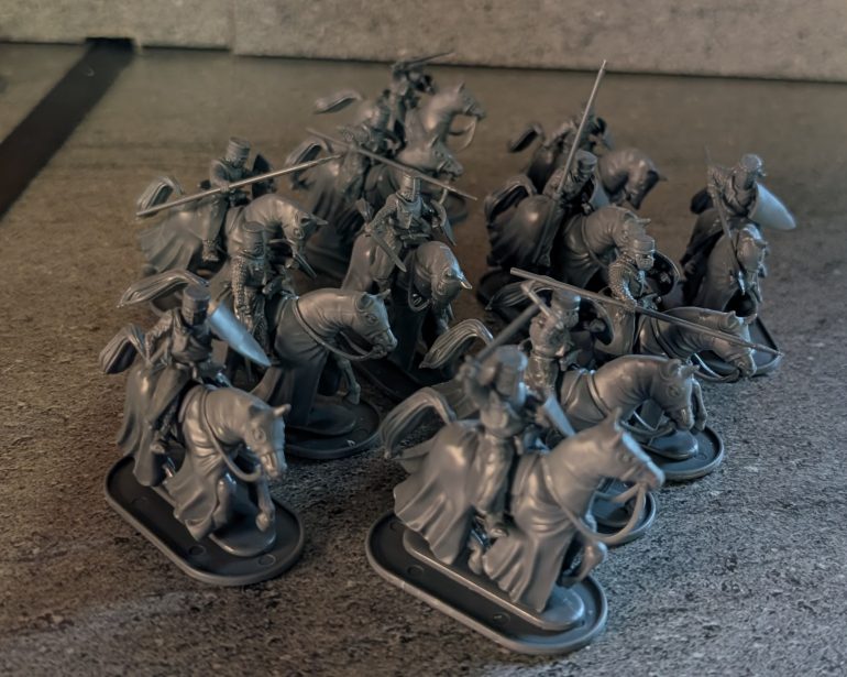 Some mounted knights, variously armed with lances and swords