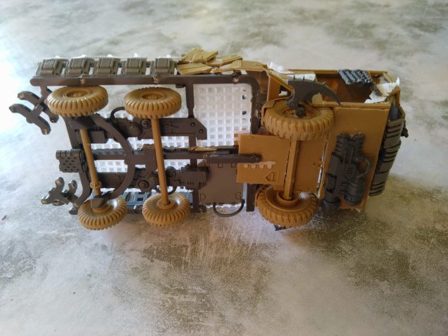 I used a chunky sprue (The one that comes with the Blood Bowl rulers) to give me a chassis for the rest of the truck. Granny grating over Wardog spare weapon halves gave me a flooring. I wanted the weapon halves to give me a look of something mechanical going on under the Trukk..   