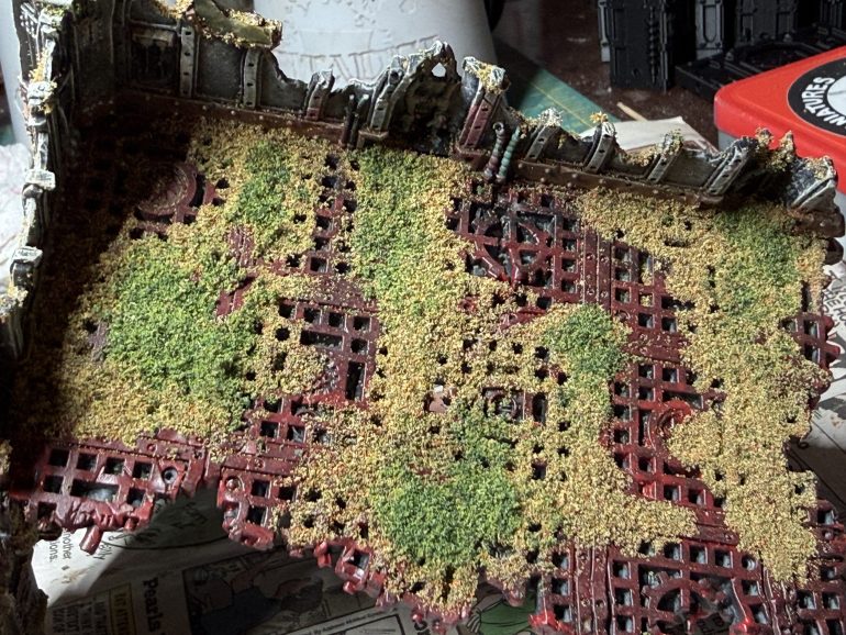Next, once the wash if dry, select two separate colors of flock (one darker than the other but fitting harmoniously with is) and apply if to the ruins with white glue. Vegetations grows in cravasses, over the walls, on the floors, and is slowly but surely gaining controls of the ruins. Have fun, go wild...