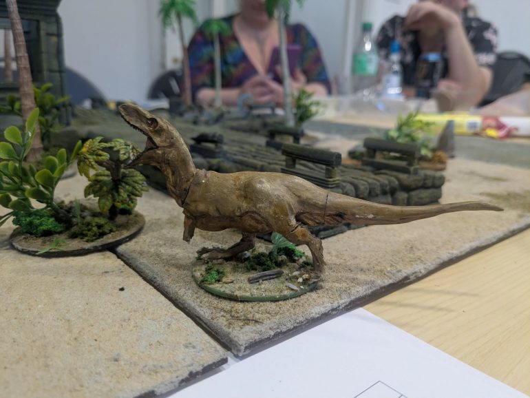 As a Dino appears on the table searching for a snack. One surviving goon breaks from the melee ho reach the second stone.