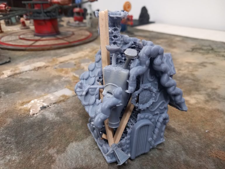 My table for kiddie kingdom was missing some blocking terrain that fits the theme. I found a print for a ginger house but he print failed. So not to waste it I turned into a ruin with the mascot bottle sticking out of the roof.