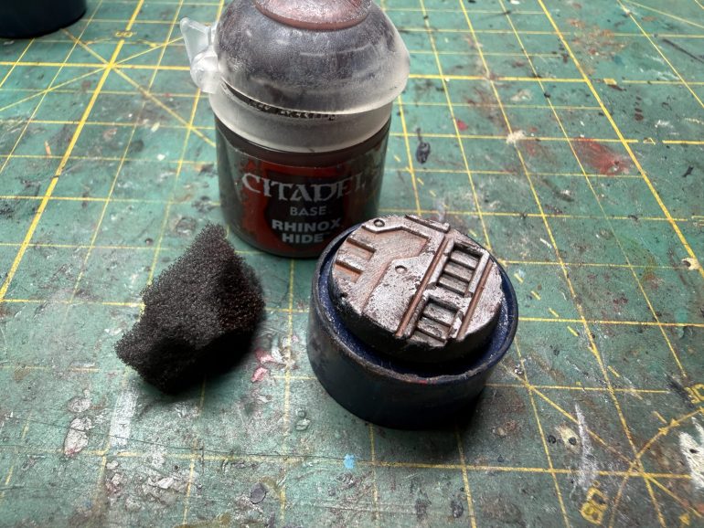Dry brush the base with a light grey and then use a sponge to create dark marks around the edges. I used GW Rhinox Hide but will use carft Burn Umber moving forward.