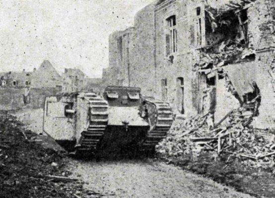 A_tank_moving_down_the_ruins_of_a_village_on_the_Cambrai_battle-front_SMALL